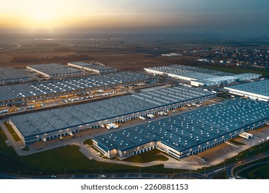Top view of warehouses, aerial view of large logistics warehouses in the evening