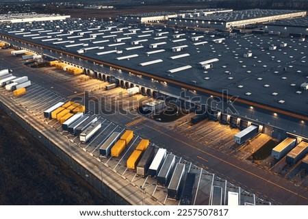 Top view of warehouses, aerial view of large logistics warehouses in the evening
