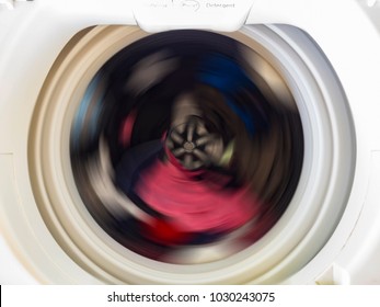 Top View Of A Washing Machine Drum During Spinning Clothes. Top Loading Washing Machine Washes Laundry.