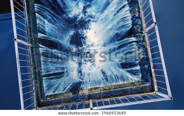 Top view of a waterfall with a stream of water on\
the lake