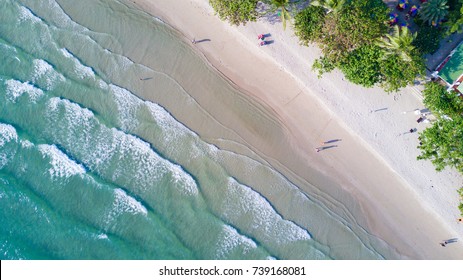 Top View Of Waves On The Sea. Above The White Sand Beach On Tropical Island. Aerial Top View Scenic Seascape.