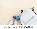 Top view of white backpack with men accessories, flatlay.