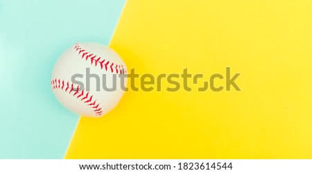 Top view of white baseball ball with red seam mockup on yellow blue color paper background,Empty round fastball for base tournament mock up, isolated.Japna and USA game championship mokcup template.