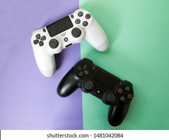 Top view of the white and black joysticks Sony Dualshock for Sony Playstation. Kyiv, Ukraine - August 2019 