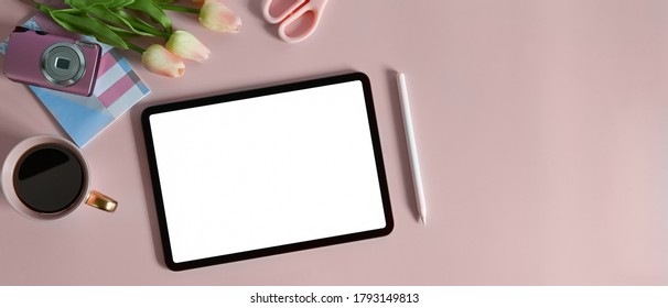 The Top View Of A White Blank Screen Computer Tablet Is Putting On A Table Surrounded By Various Feminine Equipment.