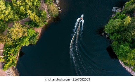 Top view of a white boat sailing in the blue sea. Top view of the boat. Aerial view luxury motor boat. A boat with a motor on blue water. High quality photo