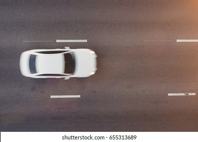 Top View Of White Car Moving On A Concrete Road