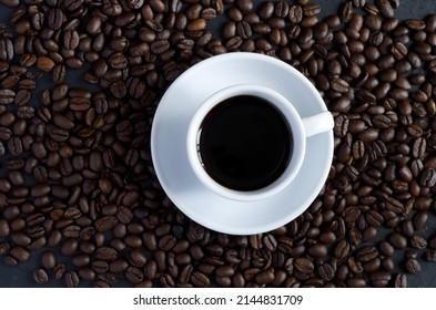 Top View of White Coffee Cup Surrounded with Coffee Beans Horizontal