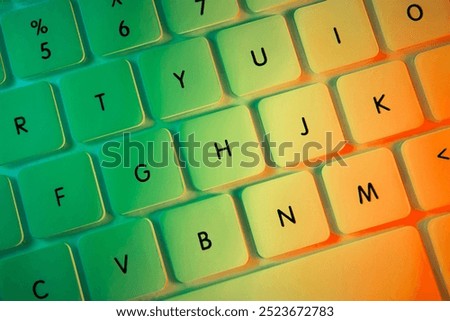 Top view of white computer keyboard illuminated with colorful lights, close-up shot