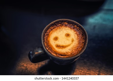 Top View White Cup Of Hot Latte Art Coffee On Wooden Background. Smiley Coffee