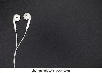 Top view of White Earphones on Black background. Copy space. Music is my life concept - Shutterstock ID 700442746