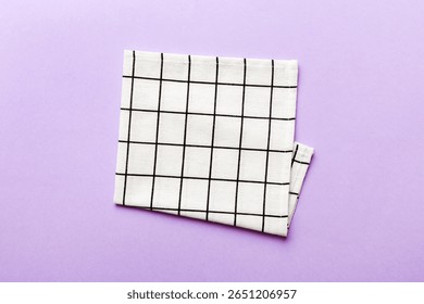 top view with white empty kitchen napkin isolated on table background. Folded cloth for mockup with copy space, Flat lay. Minimal style.