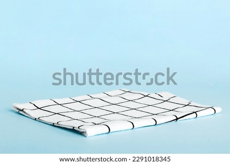 top view with white empty kitchen napkin isolated on table background. Folded cloth for mockup with copy space, Flat lay. Minimal style.
