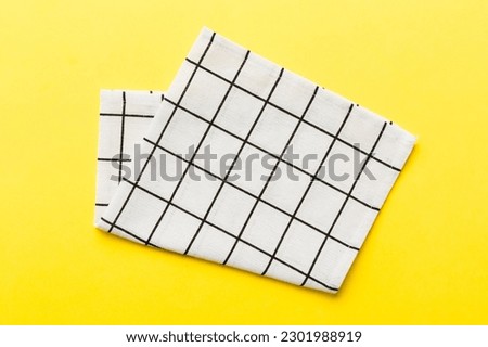 top view with white empty kitchen napkin isolated on table background. Folded cloth for mockup with copy space, Flat lay. Minimal style.