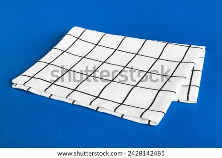 top view with white empty kitchen napkin isolated on table background. Folded cloth for mockup with copy space, Flat lay. Minimal style.