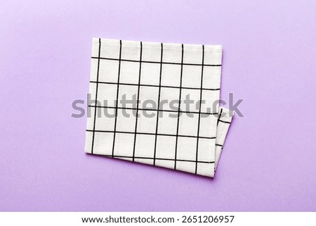 top view with white empty kitchen napkin isolated on table background. Folded cloth for mockup with copy space, Flat lay. Minimal style.