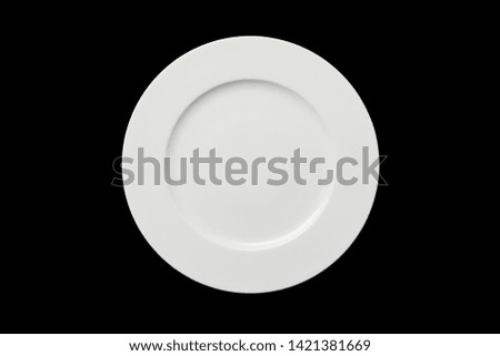 top view of white empty round plate isolated on black