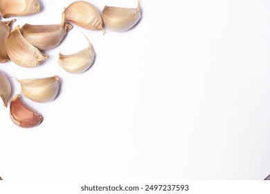 Top view of white garlic cloves, Chinese garlic. On white background dry food ingredients. For presentation, food, education, and garlic advertising. - Powered by Shutterstock