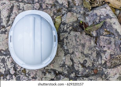 Top view a white hard safety helmet hat for safety project of workman as engineer or worker, on nature floor