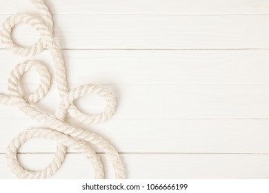 Top View Of White Nautical Rope On Wooden Surface