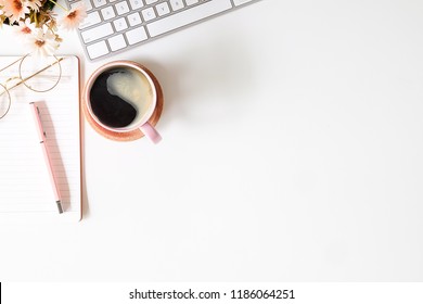 Top view white office desk table with blank notebook, computer keyboard and other office supplies. with copy space, flat lay. - Powered by Shutterstock