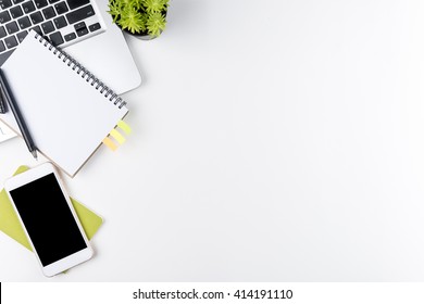 Top view of white office table with laptop, smartphone and supplies. Top view with copy space. - Shutterstock ID 414191110
