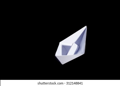 Top View Of A White Origami Paper Boat On Black Background.