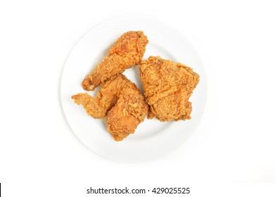 Top View Of A White Plate Of Crispy Fried Chicken Isolated On A White Background.