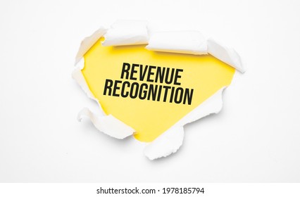 Top View Of White Torn Paper And The Text Revenue Recognition On A Yellow Background.