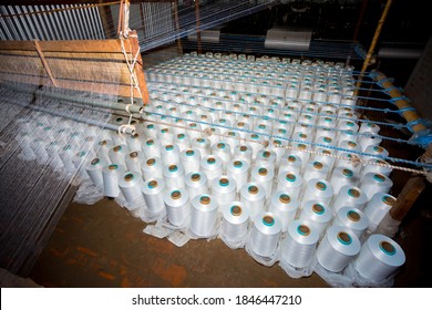 Top View Of A Lot Of White Yarn Spools In A Textile Factory. White Yarn Spools In A Clothing Factory.