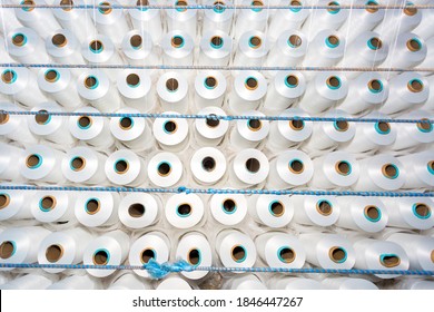 Top View Of A Lot Of White Yarn Spools In A Textile Factory. White Yarn Spools In A Clothing Factory.