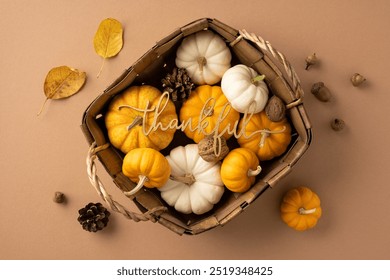 Top view of a wicker basket filled with white and orange pumpkins, pine cones, and nuts on a brown background, symbolizing a Thanksgiving harvest theme - Powered by Shutterstock