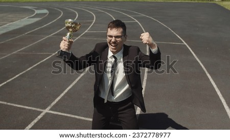 Top View Of The Winning Corporate Business Man In An Office Suite With A Cup In