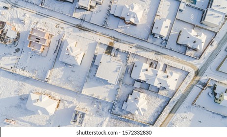 Top View Of The Winter Village With Snow Covered Houses And Roads. Aerial View Of Landscape