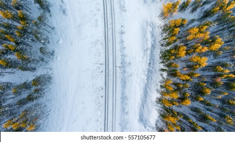 Top view at the wintry two way rail road in evergreen forest. Winter in Russia