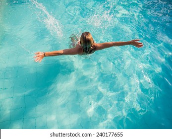 Top view of a woman in bikini at the swimming pool
