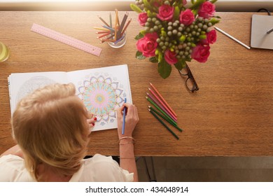 Top View Of Woman Coloring Floral Designs With Color Pencils For Relaxation At Home. Anti Stress Adult Coloring Book.