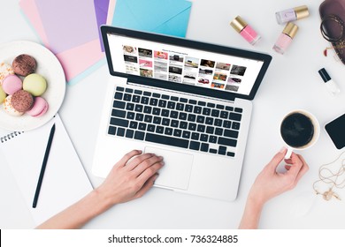 Top View Of Woman Drinking Coffee With Macaroon While Using Laptop With Pinterest Website