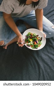Top view woman eating salad close up, top view. Healthy food concept - Shutterstock ID 1049020952