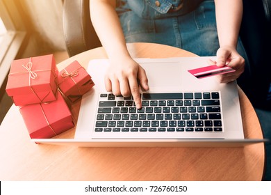Top View Of Woman Hand Holding Credit Card And Doing Shopping Online Near Window At Home.
