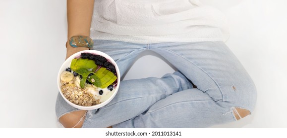 Top View Of Woman Hand With  Yogurt Blueberry ,avocado,banana,as Granola Parfait In A Bowl -Healthy Eating And Diet Plan Concept On White Background
