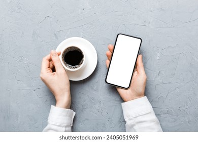 Top view of woman hands holding smart phone with blank copy space screen for your text message or information content. woman hand using phone white screen on top view. - Powered by Shutterstock