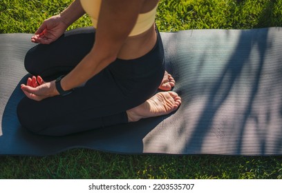 Top View Of A Woman Kneeling On A Yoga Mat Practicing Meditation Exercises. Training On Yoga Mat Outside, Enjoying Healthy Lifestyle, Closeup Shot