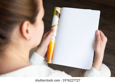 Top View Of A Woman Reading An Open Book Or Magazine. Empty Page. Mock Up