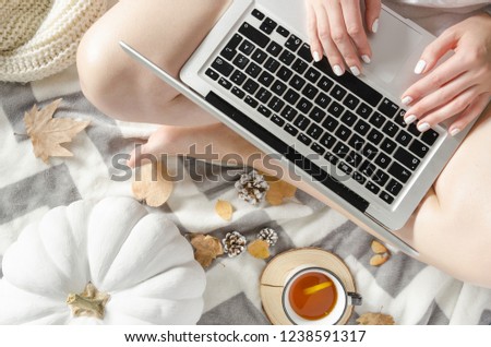 Top view of woman sitting in bad with laptop, notebook.Student studying and drink tea. Flatlay. Winter autumn mood