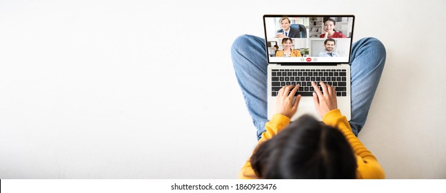 Top View Of Woman Sitting On Floor And Using Laptop Video Call Conference Her Team. Panoramic Image With Empty Copy Space