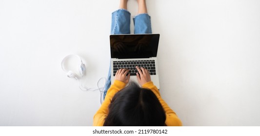 Top View Of Woman Sitting On The Floor And Using Computer Laptop