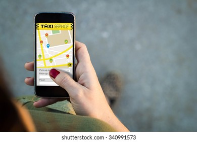 Top View Of Woman Walking In The Street Using Her Mobile Phone With Taxi Service In The Screen With Copyspace. All Screen Graphics Are Made Up.