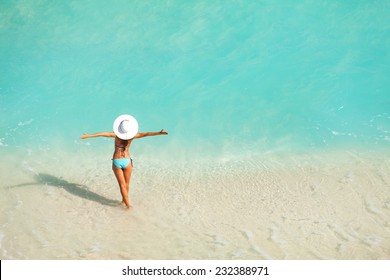 Top View Of Woman With White Hat Standing In Ocean