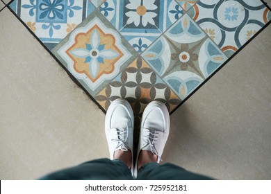 Top View Of Woman's Legs Standing On The Floor With Mosaic Tile